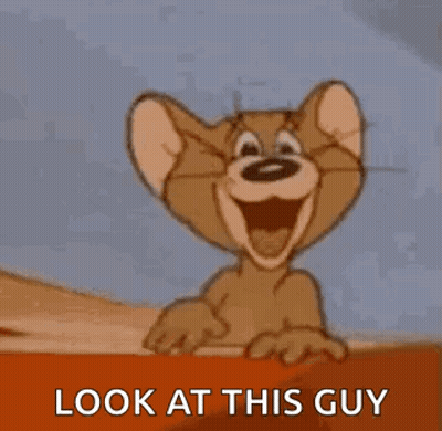 Jerry From Tom And Jerry Is Smiling And Pointing At The Camera . GIF
