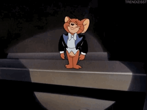 Jerry From Tom And Jerry Is Wearing A Tuxedo And Standing On A Stage GIF