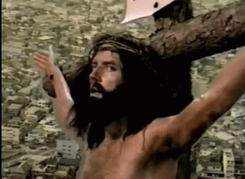 Jesus On Cross With Arms Outstretched Before City GIF