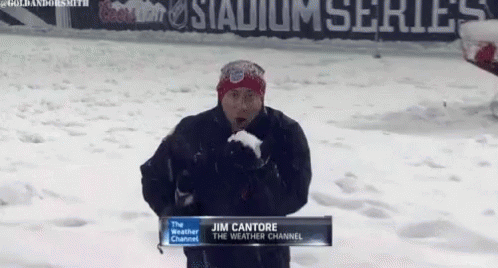 Jim Cantore Is Standing In The Snow Holding A Snowball GIF