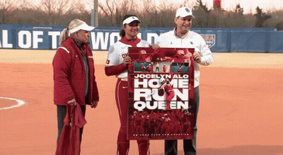 Jocelyn Alo Is The Home Run Queen And Is Holding A Poster GIF