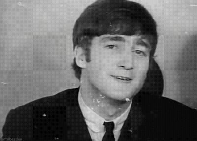 John Lennon Making Funny Face In Suit And Tie GIF