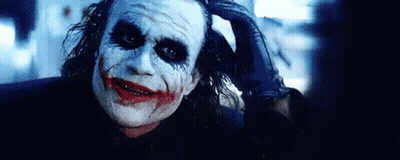 Joker From The Dark Knight Rises Holding Hand To Head GIF