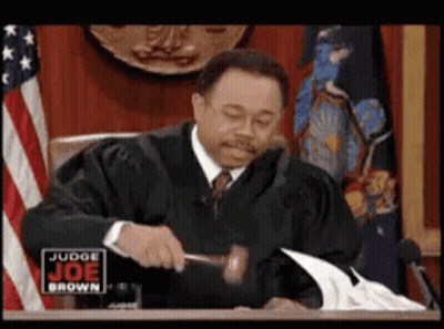 Judge Holding Gavel In Front Of American Flag GIF