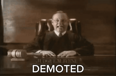 Judge Sitting At Desk With Word Demoted GIF