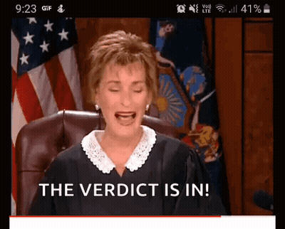 Judge Sitting In Front Of American Flag GIF