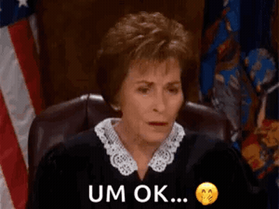 Judge Sitting In Front Of American Flag GIF