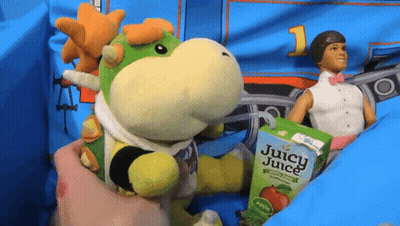 Juice Box Beside Stuffed Animal And Doll GIF