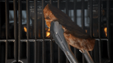 Juicy Meat Steak Flipping Over Flaming Charcoals GIF