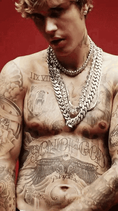 Justin Bieber Has A Lot Of Tattoos On His Chest And Torso . GIF