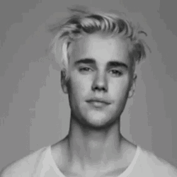 Justin Bieber In His Messy Hair And Winking GIF