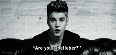 Justin Bieber Is Sitting On A Couch In A Black And White Photo And Says `` Are You A Believer ? '' GIF