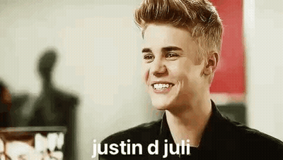 Justin Bieber Is Smiling While Wearing A Black Jacket And A Black Shirt . GIF