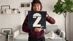 Justin H Min Holding Card Number Two GIF