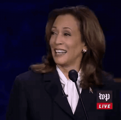 Kamala Harris Is Smiling While Giving A Speech At A Podium . GIF