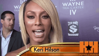 Keri Hilson Standing In Front Of Cash Money Records Sign GIF