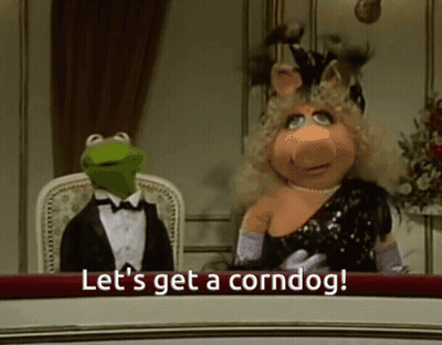 Kermit And Miss Piggy At Table Saying Let's Get A Corndog GIF