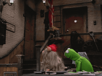 Kermit And Miss Piggy Sitting At Table Beside Dressing Room Sign GIF