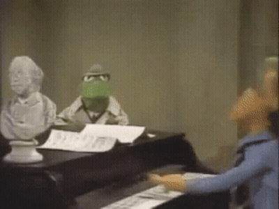 Kermit Playing Piano In Front Of Statue GIF