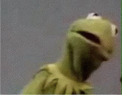 Kermit The Frog From Sesame Street Is Looking At The Camera With His Mouth Open . GIF