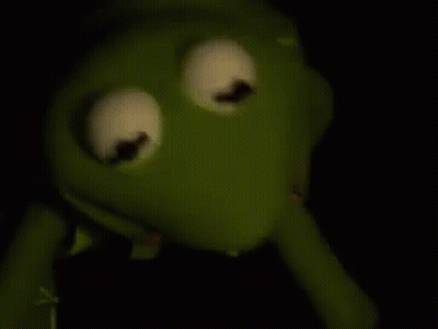 Kermit The Frog From The Muppet Show Is Holding A Syringe In His Mouth . GIF