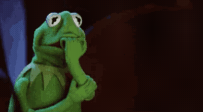 Kermit The Frog Is Covering His Mouth With His Hand And Looking At The Camera . GIF