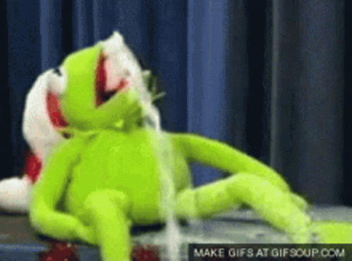Kermit The Frog Is Laying Down With His Mouth Open And A Gif Is Being Made At Gifsoup.com GIF