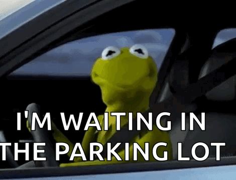 Kermit The Frog Is Sitting In A Car Waiting In The Parking Lot GIF