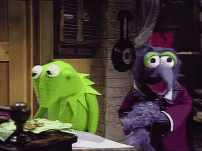 Kermit The Frog Is Sitting Next To A Stuffed Animal GIF