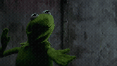 Kermit The Frog Is Standing In Front Of A Wall With His Mouth Wide Open GIF