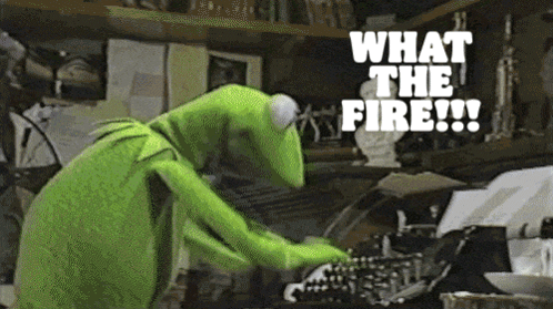 Kermit The Frog Is Typing On A Typewriter With The Words What The Fire Written Above Him GIF
