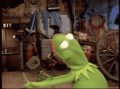 Kermit The Frog Stands In Front Of A Sign That Says Exit GIF