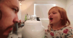 Kid Blow Smoke To Her Father GIF