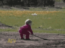 Kid Digging Spilling Soil In His Face GIF