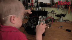 Kid Playing Electronics GIF