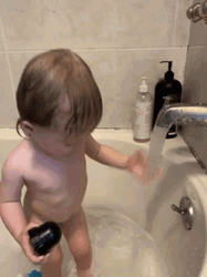 Kid Plays Water During Bath Time GIF