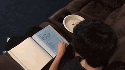 Kid Reading Book Flips Pages