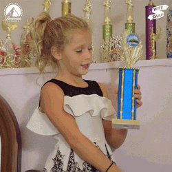 Kid Showing Off Trophy GIF