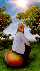Kid Sitting On Bouncing Peach GIF
