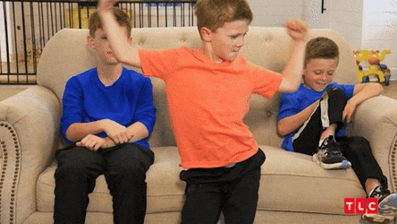 Kids On Couch Young Boy Showing Off GIF