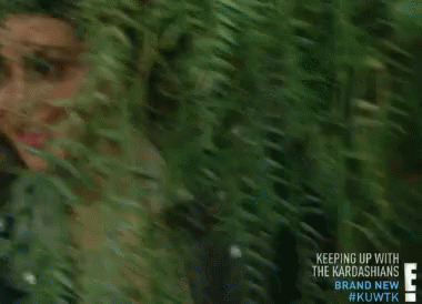 Kim Kardashian Is Smiling While Standing In A Forest GIF