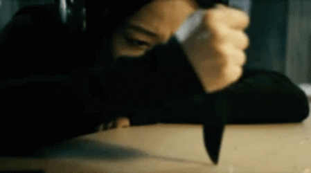Kimiko With Headphones Holding A Knife GIF