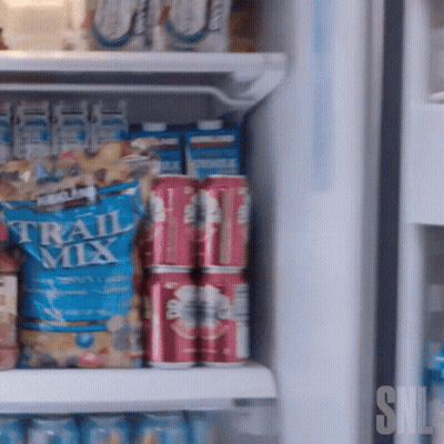 Kirkland Trail Mix Bag On Refrigerator Shelf With Soda Cans GIF