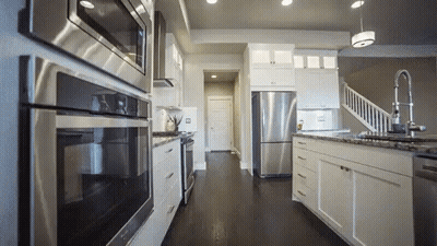 Kitchen With White Cabinets And Stainless Steel Appliances GIF