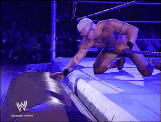 Kneeling Man In Wrestling Ring With W Logo GIF