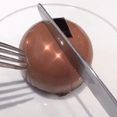 Knife Cutting Chocolate Ball With Fork GIF