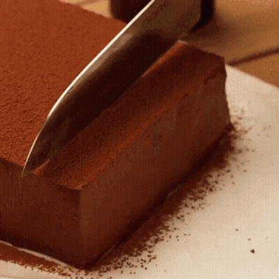 Knife Cutting Chocolate Cake With Cocoa Powder GIF