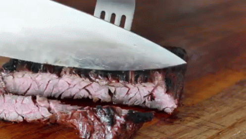 Knife Cutting Steak On Wooden Board GIF
