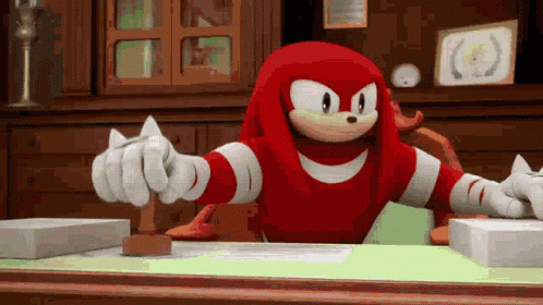 Knuckles The Echidna From The Video Game Sonic The Hedgehog Is Sitting At A Desk With A Stamp On It . GIF