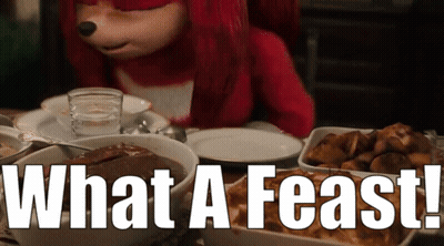 Knuckles The Hedgehog Is Sitting At A Table With Plates Of Food And The Words What A Feast GIF